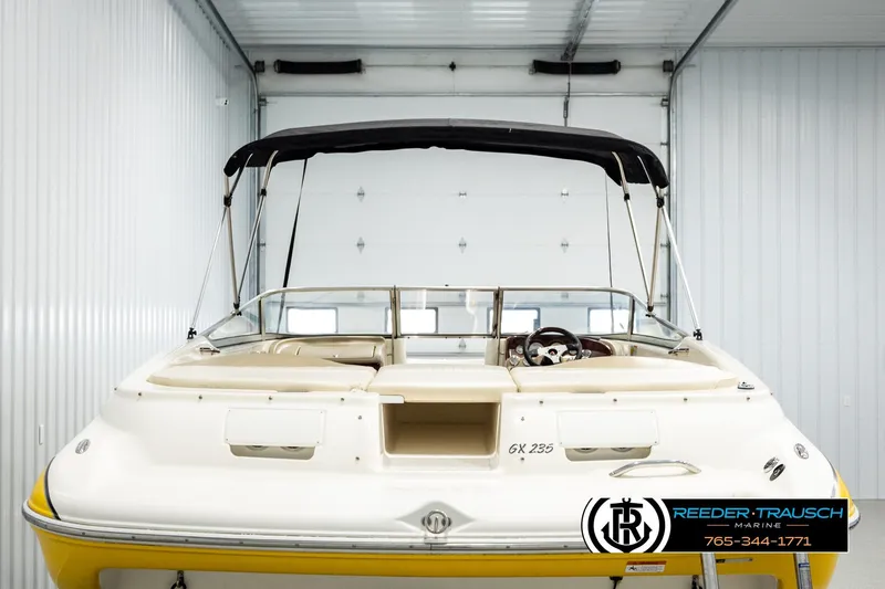 Slide: The Image of 2006 Glastron GX 235 boat with canopy in storage facility. - 7