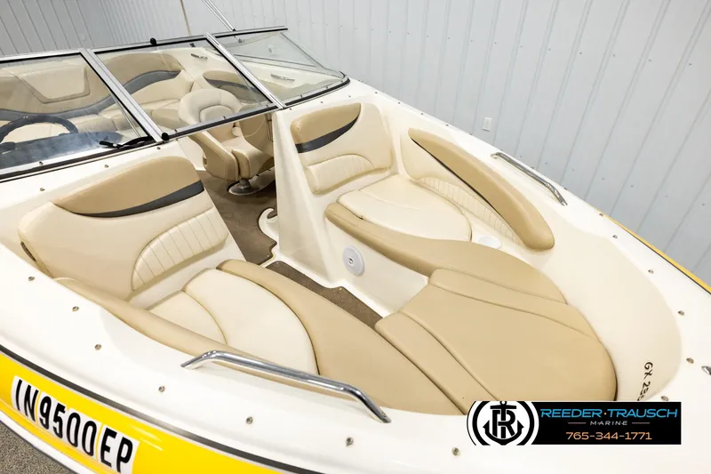 Slide: The Image of 2006 Glastron GX 235 boat interior with beige seating and windshield. - 9