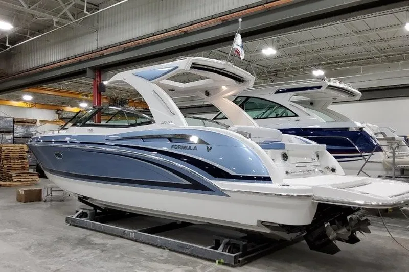 Slide: The Image of 2023 Formula 350 Crossover Bowrider I/O in a showroom, showcasing sleek design and luxury features. - 2