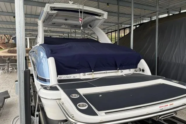 Slide: The Image of 2023 Formula 350 Crossover Bowrider I/O in dock, covered and ready for use. - 3