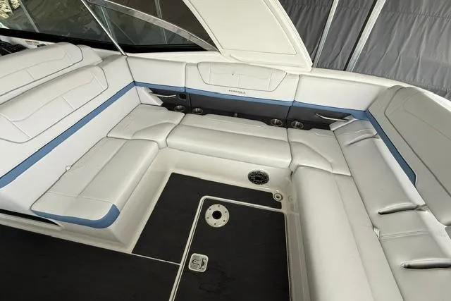 Slide: The Image of 2023 Formula 350 Crossover Bowrider I/O interior with white seating and blue accents. - 6