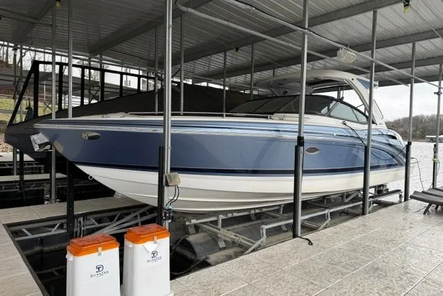 Slide: The Image of 2023 Formula 350 Crossover Bowrider I/O in docked position under covered marina. - 7