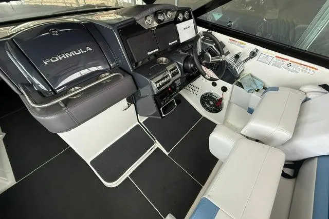 Slide: The Image of 2023 Formula 350 Crossover Bowrider I/O cockpit with modern controls and seating. - 9