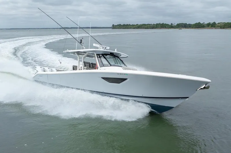The Image of 2023 Pursuit S 428 Sport boat cruising on open water, showcasing sleek design and performance. - 0