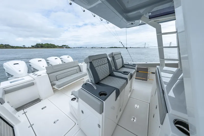 Slide: The Image of 2023 Pursuit S 428 Sport boat interior with seating and ocean view. - 13