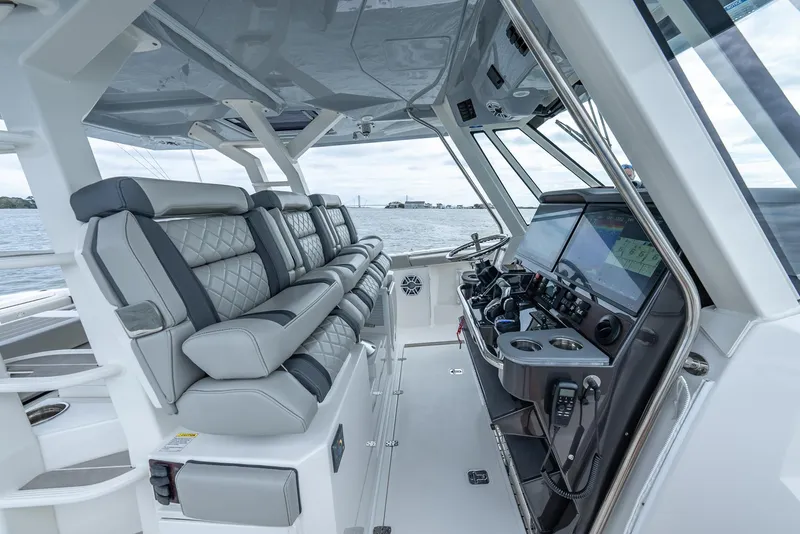 Slide: The Image of 2023 Pursuit S 428 Sport boat interior with luxurious seating and advanced navigation controls. - 18