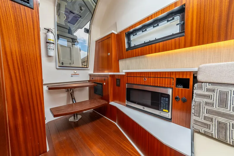 Slide: The Image of Luxurious interior of 2023 Pursuit S 428 Sport boat with wood finish and modern amenities. - 32