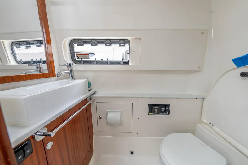 Slide: The Image of 2023 Pursuit S 428 Sport boat bathroom with sink, mirror, and toilet. - 34