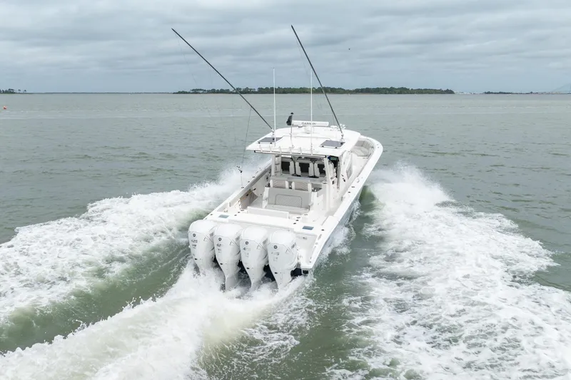 Slide: The Image of 2023 Pursuit S 428 Sport boat cruising on open water, rear view. - 6