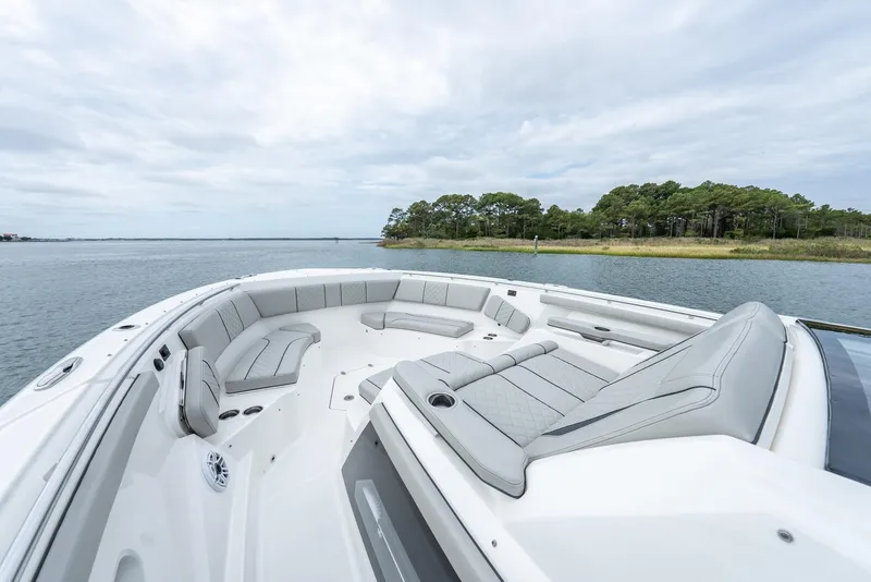Slide: The Image of 2023 Pursuit S 428 Sport boat with spacious seating on calm water. - 7