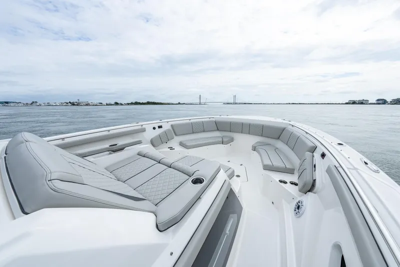 Slide: The Image of 2023 Pursuit S 428 Sport boat with spacious seating on calm waters. - 9