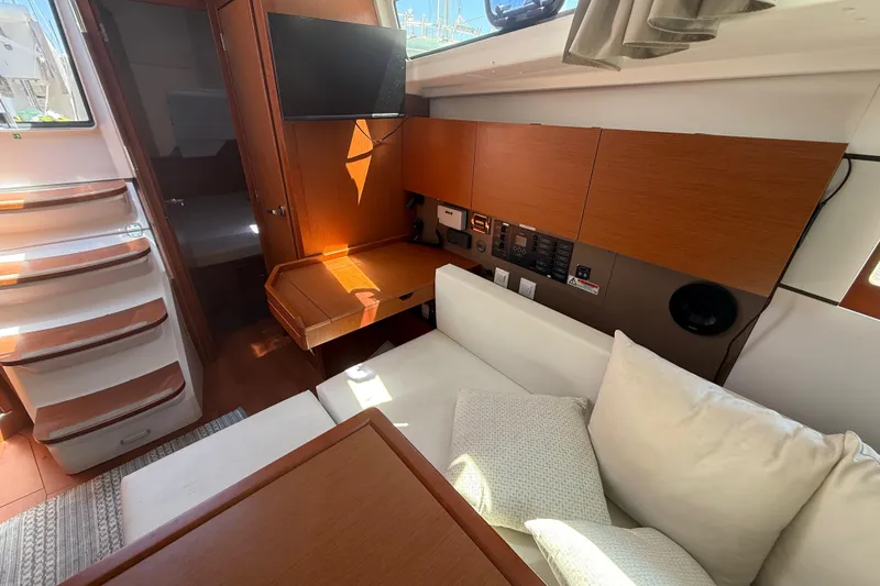 Slide: The Image of Interior of 2016 Beneteau Oceanis 38.1 yacht with cozy seating and modern amenities. - 16
