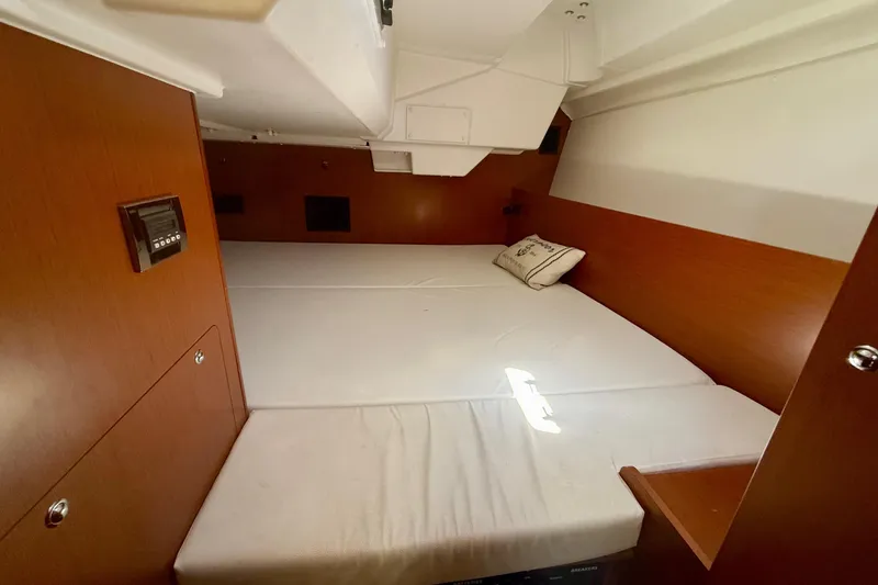 Slide: The Image of Interior cabin of 2016 Beneteau Oceanis 38.1 with wooden finish and cozy bed. - 19