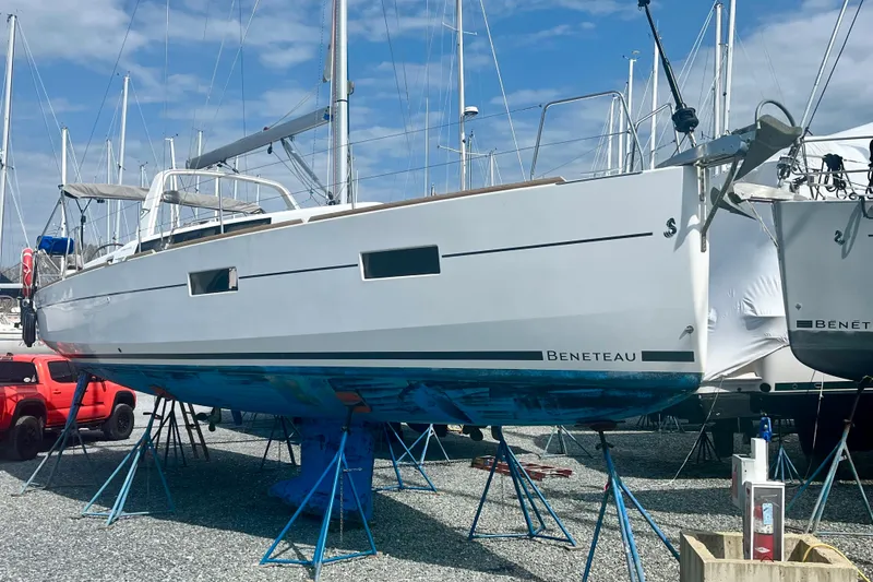 Slide: The Image of 2016 Beneteau Oceanis 38.1 sailboat on stands in a marina. - 2