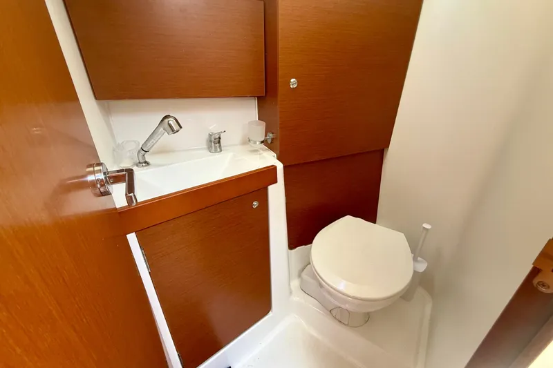 Slide: The Image of Beneteau Oceanis 38.1 2016 yacht bathroom with wooden cabinetry and compact sink. - 20
