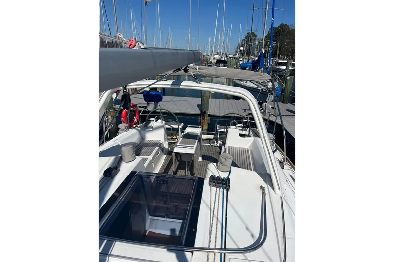 Slide: The Image of 2016 Beneteau Oceanis 38.1 sailboat docked at marina, showcasing cockpit and helm. - 4