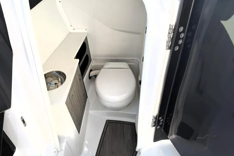 Slide: The Image of 2022 Monterey 255SS Super Sport boat interior bathroom with toilet and sink. - 19