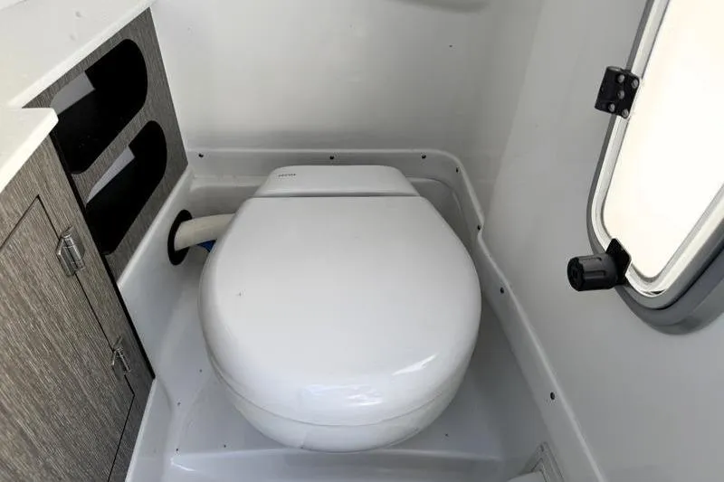 Slide: The Image of 2022 Monterey 255SS Super Sport boat bathroom with compact toilet and storage cabinet. - 20