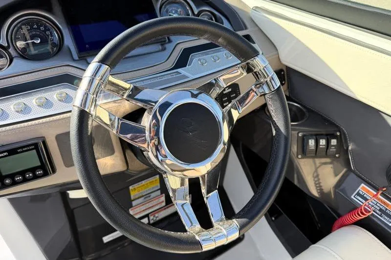 Slide: The Image of Steering wheel of 2022 Monterey 255SS Super Sport boat with modern dashboard controls. - 27
