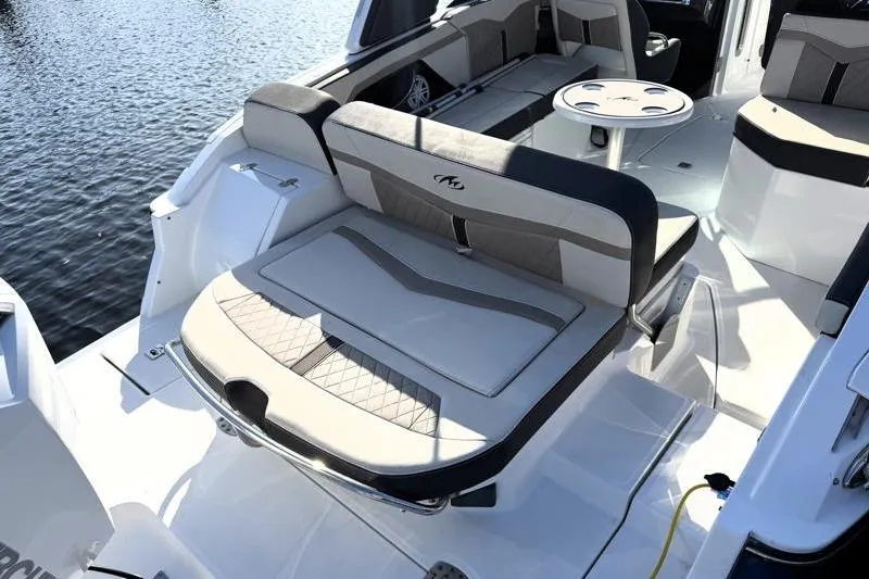 Slide: The Image of 2022 Monterey 255SS Super Sport boat interior with seating and table on water. - 35
