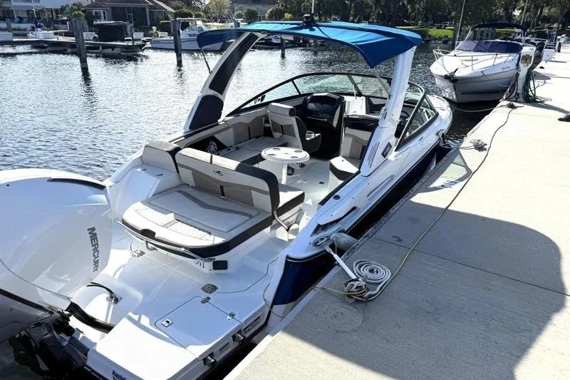 Slide: The Image of 2022 Monterey 255SS Super Sport boat docked at marina with blue canopy. - 4