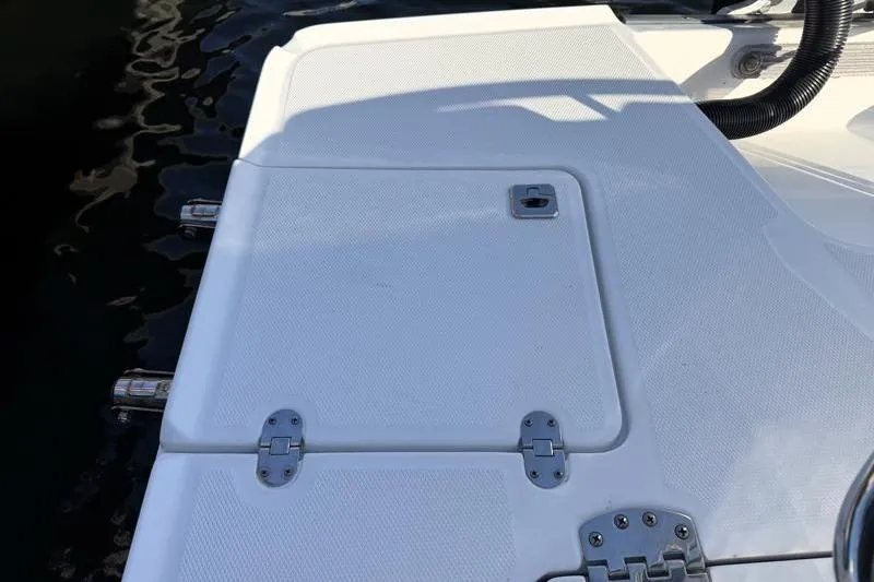 Slide: The Image of 2022 Monterey 255SS Super Sport boat deck with hatch and hinges. - 43