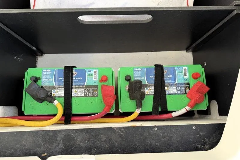 Slide: The Image of Dual marine batteries in a 2022 Monterey 255SS Super Sport boat compartment. - 48