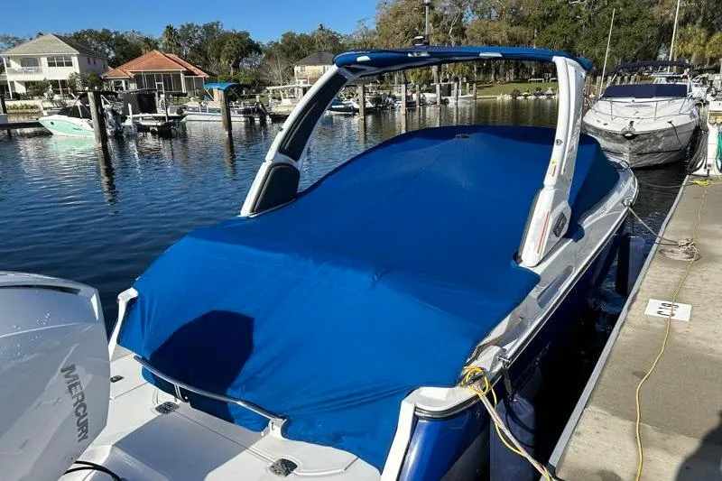 Slide: The Image of 2022 Monterey 255SS Super Sport boat docked with blue cover in marina. - 5
