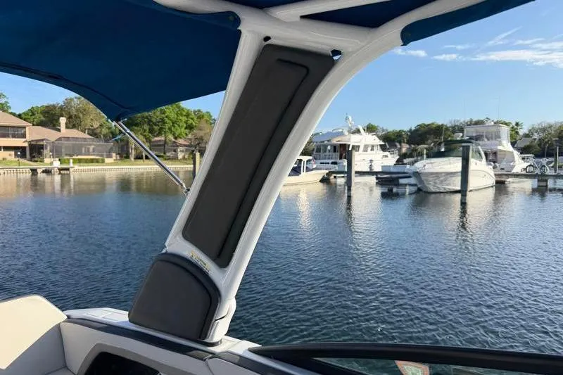 Slide: The Image of 2022 Monterey 255SS Super Sport boat docked at a marina under blue skies. - 52