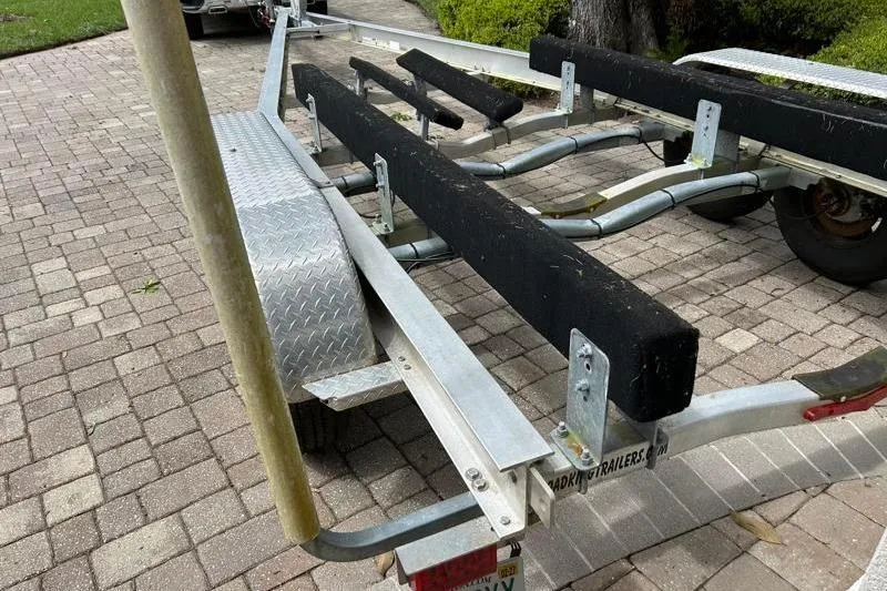 Slide: The Image of Boat trailer for 2022 Monterey 255SS Super Sport on paved driveway. - 54