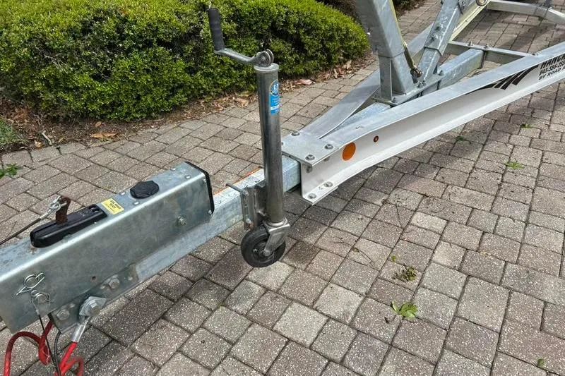 Slide: The Image of Trailer hitch and wheel for 2022 Monterey 255SS Super Sport on brick pavement. - 56