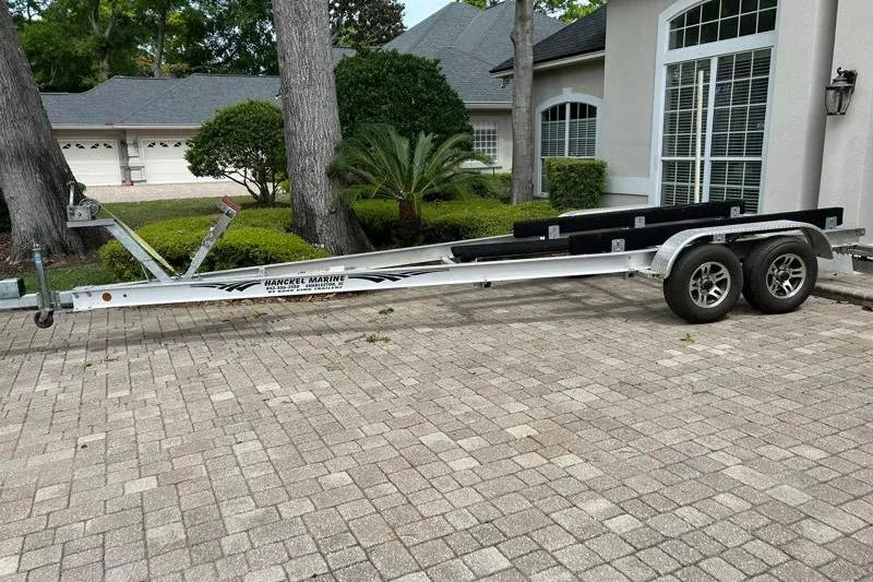 Slide: The Image of Trailer for 2022 Monterey 255SS Super Sport boat parked on brick driveway. - 7