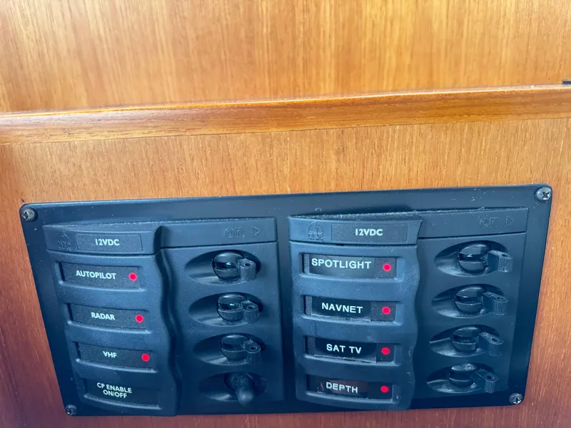 Slide: The Image of Control panel on 2009 Grand Banks 45 Eastbay SX with labeled switches for navigation and communication. - 14