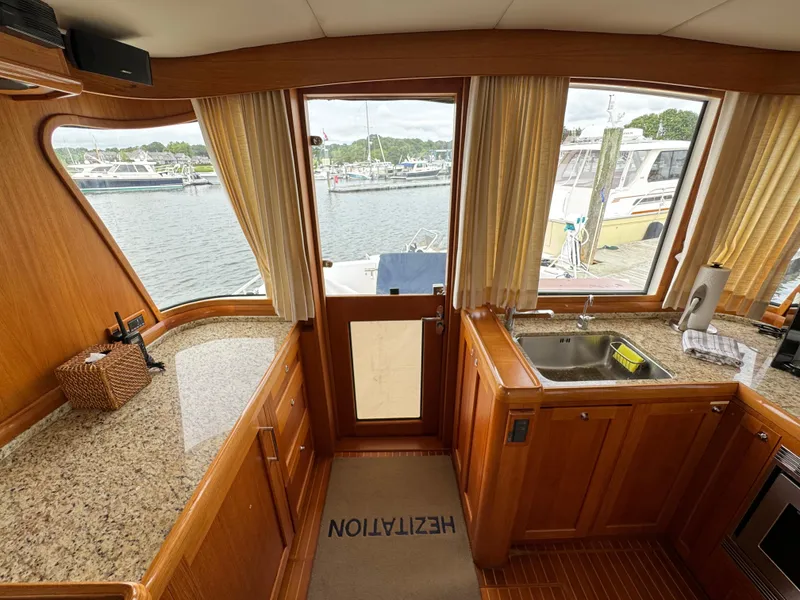 Slide: The Image of Interior of 2009 Grand Banks 45 Eastbay SX yacht with wooden cabinetry and granite countertops. - 21