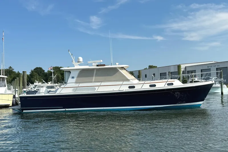 Slide: The Image of 2009 Grand Banks 45 Eastbay SX yacht docked in marina under clear blue sky. - 3