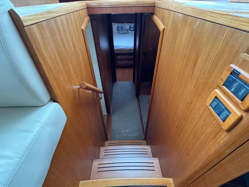 Slide: The Image of Interior view of 2009 Grand Banks 45 Eastbay SX yacht, featuring wooden stairs and cabin entrance. - 30
