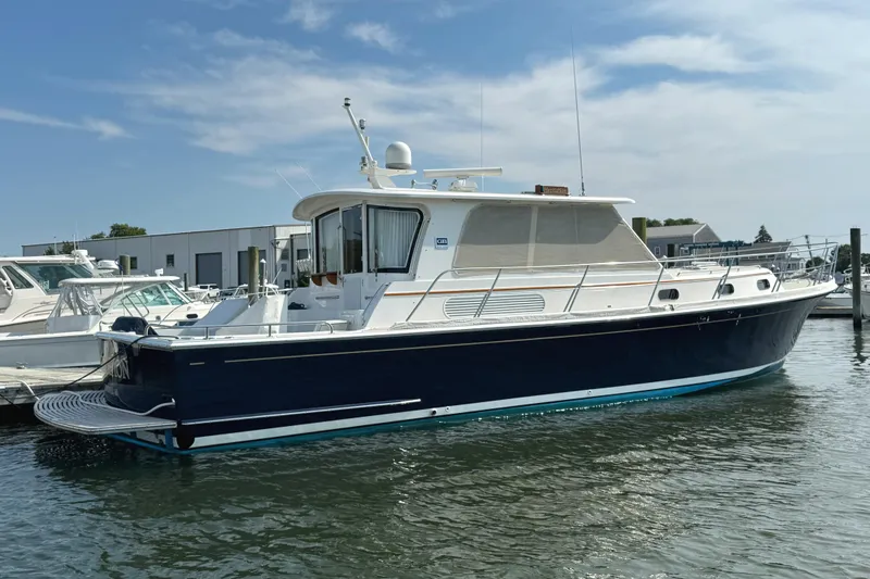 Slide: The Image of 2009 Grand Banks 45 Eastbay SX yacht docked in a marina under a clear sky. - 4