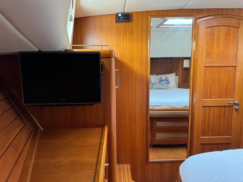 Slide: The Image of Interior of 2009 Grand Banks 45 Eastbay SX with wood paneling, TV, and mirror. - 43
