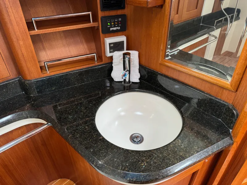 Slide: The Image of 2009 Grand Banks 45 Eastbay SX bathroom with granite countertop and sink. - 48