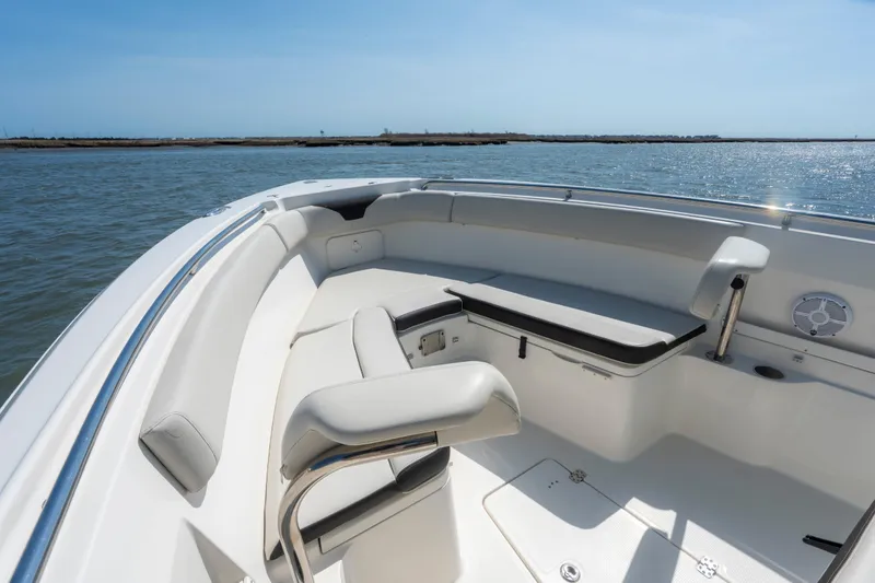 Slide: The Image of 2023 Sailfish 290 CC boat interior with cushioned seating, ocean view. - 16