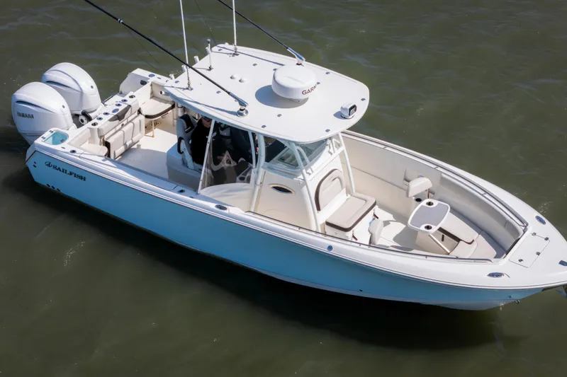 Slide: The Image of 2023 Sailfish 290 CC boat with dual Yamaha engines on water. - 4