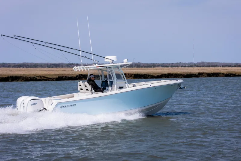 Slide: The Image of 2023 Sailfish 290 CC boat cruising on water with fishing rods and Yamaha engines. - 7