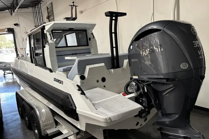 Slide: The Image of 2026 Iron 907 Coupe boat with Yamaha engine on trailer in warehouse. - 10