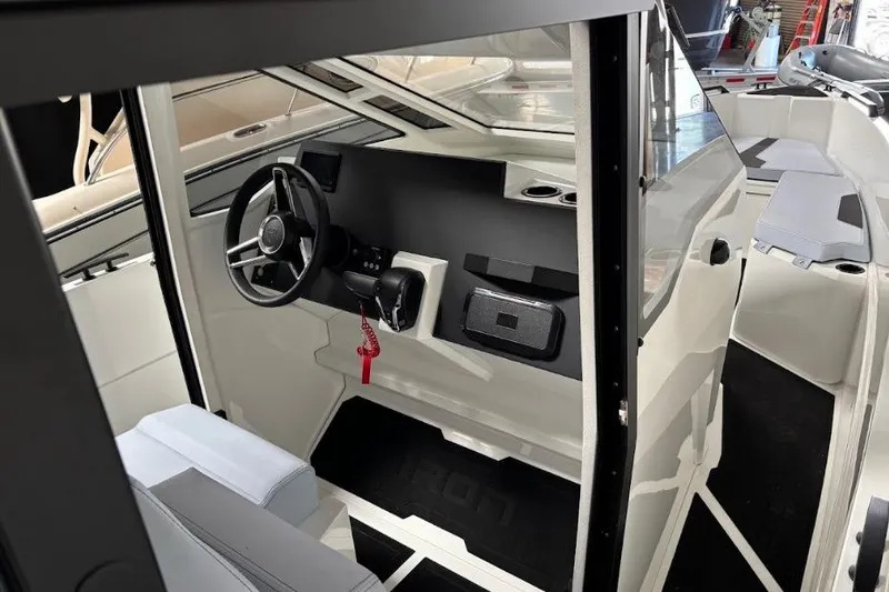 Slide: The Image of Interior of a 2026 Iron 907 Coupe boat, featuring a sleek steering area. - 14