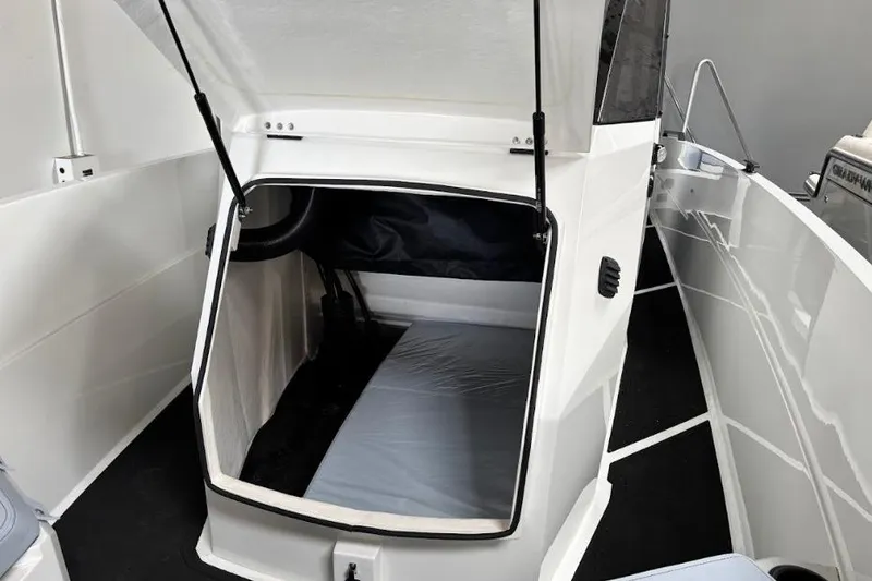 Slide: The Image of 2026 Iron 907 Coupe boat interior with open cabin and sleek design. - 16