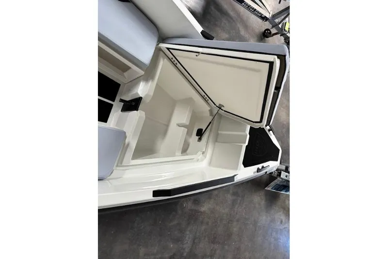 Slide: The Image of Open storage compartment in a 2026 Iron 907 Coupe boat, showcasing interior space. - 17