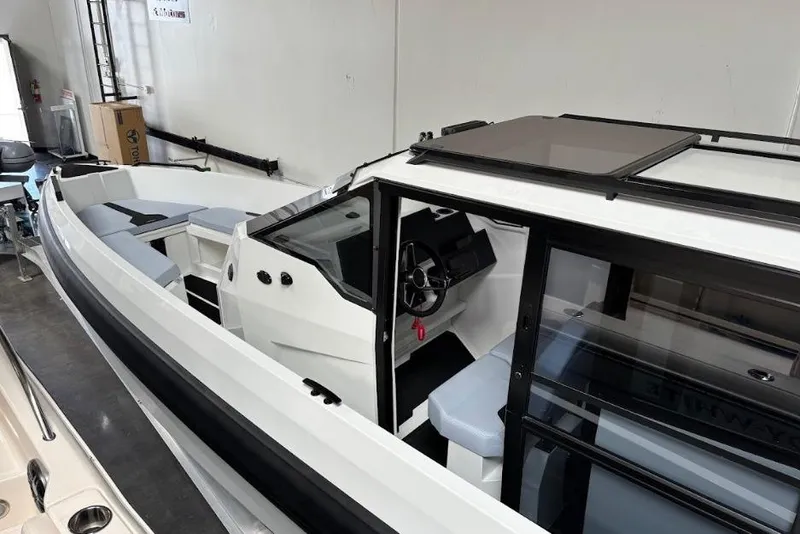 Slide: The Image of 2026 Iron 907 Coupe boat interior with modern design and sleek seating. - 22