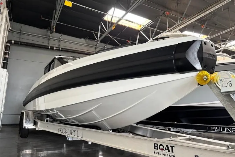 Slide: The Image of 2026 Iron 907 Coupe boat on trailer in indoor storage facility. - 23