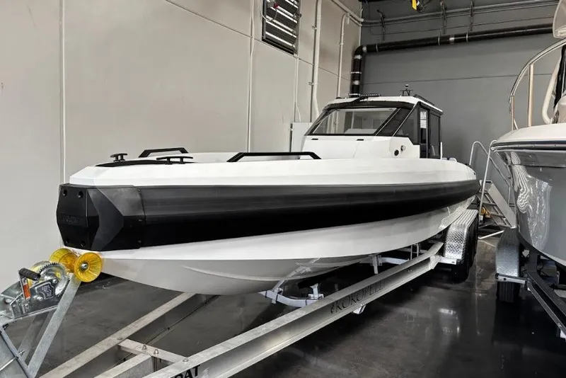 Slide: The Image of 2026 Iron 907 Coupe boat on trailer in indoor storage facility. - 6