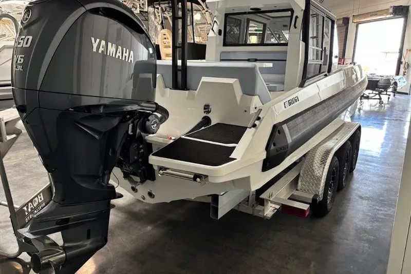 Slide: The Image of 2026 Iron 907 Coupe boat with Yamaha V6 engine on trailer in showroom. - 8